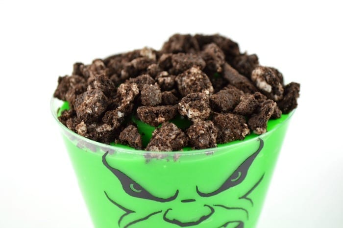 Spoon the green pudding into the Hulk cups and top with crushed Oreos