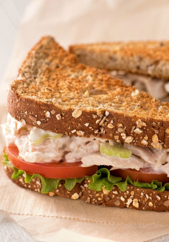 tuna salad on toasted wheat bread with tomatoes and lettuce