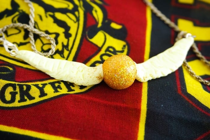 Seriously, I can't believe I caught it! Dude, this DIY Snitch Necklace is made to be Chased (and worn)! And it's so easy. #harrypotter #snitch #snitchnecklace #diyharrypotterjewelry #harrypotterjewelry #snitchjewelry