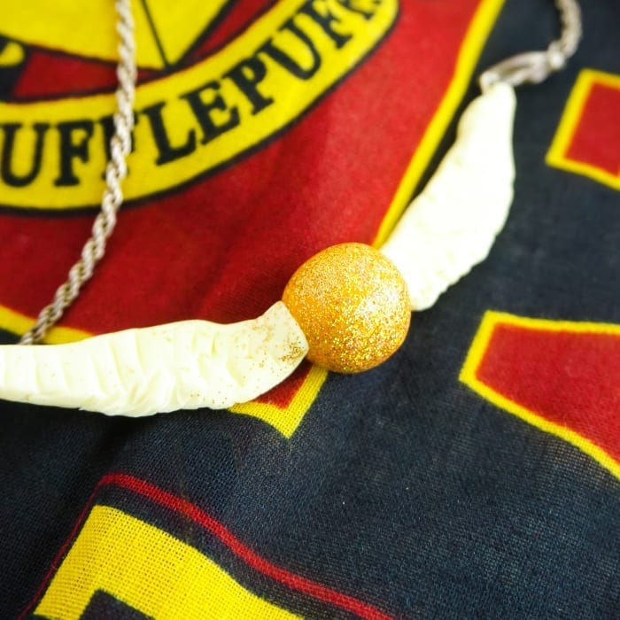 Seriously, I can't believe I caught it! Dude, this DIY Snitch Necklace is made to be Chased (and worn)! And it's so easy. #harrypotter #snitch #snitchnecklace #diyharrypotterjewelry #harrypotterjewelry #snitchjewelry