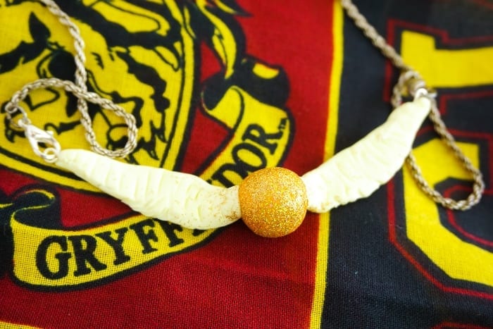 Seriously, I can't believe I caught it! Dude, this DIY Snitch Necklace is made to be Chased (and worn)! And it's so easy. #harrypotter #snitch #snitchnecklace #diyharrypotterjewelry #harrypotterjewelry #snitchjewelry
