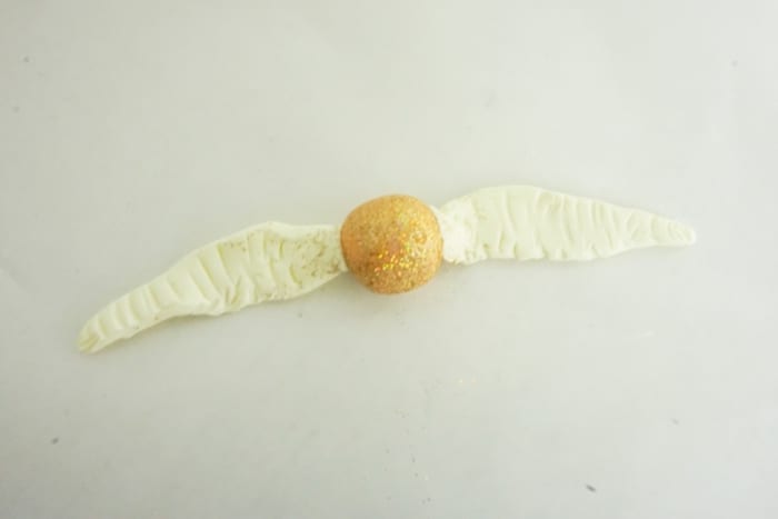 Seriously, I can't believe I caught it! Dude, this DIY Snitch Necklace is made to be Chased (and worn)! And it's so easy. #harrypotter #snitch #snitchnecklace #diyharrypotterjewelry #harrypotterjewelry #snitchjewelry