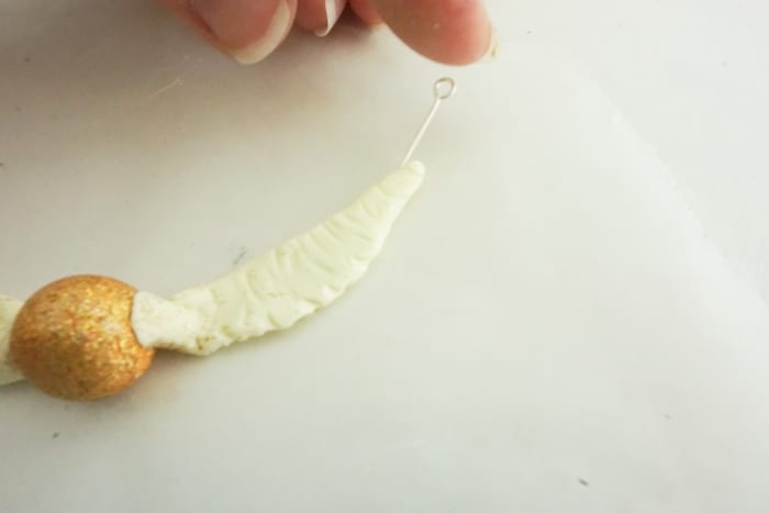 Seriously, I can't believe I caught it! Dude, this DIY Snitch Necklace is made to be Chased (and worn)! And it's so easy. #harrypotter #snitch #snitchnecklace #diyharrypotterjewelry #harrypotterjewelry #snitchjewelry