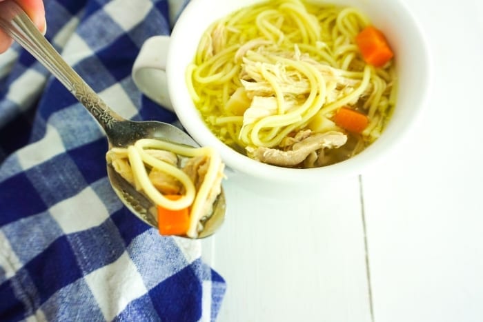 When I get sick or my kids are sick, I always want soup. And this is the Easiest Homemade Chicken Noodle Soup on the Planet. It'll knock your socks off with flavor. #chickennoodlesoup #howtomakechickennoodlesoup #homemadechickennoodlesoup