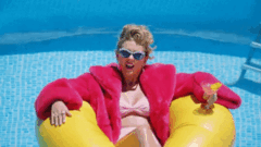 Taylow Swift in a pool floatie saying