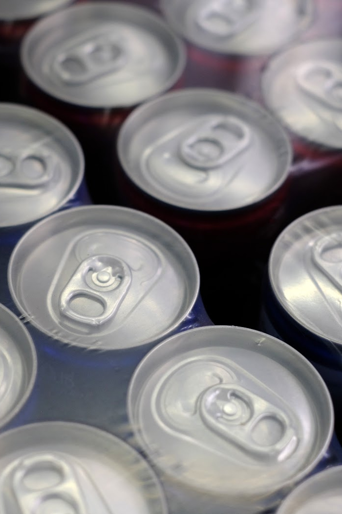 This image has an empty alt attribute; its file name is soda-cans-.jpg