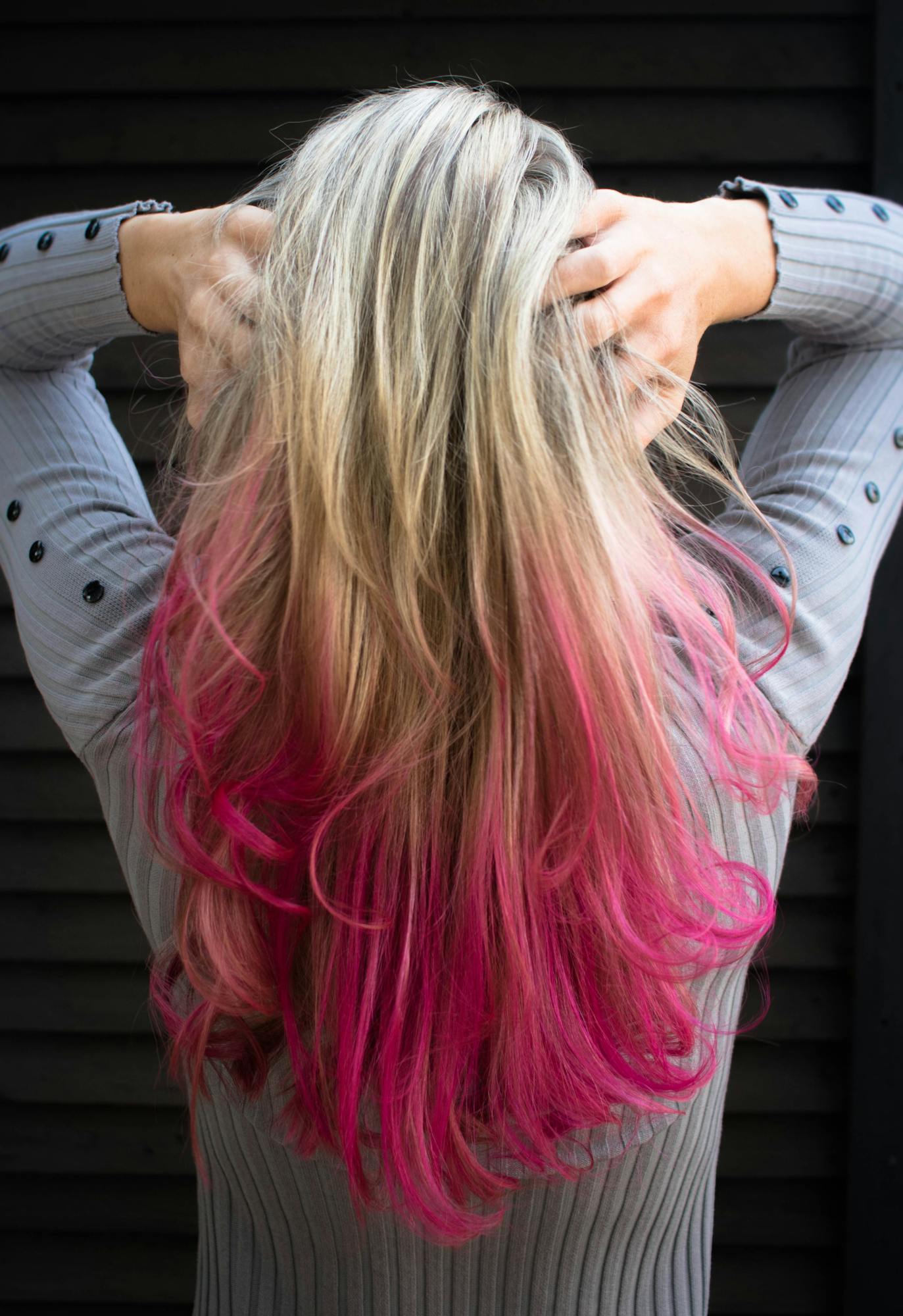Woman in Gray Long-sleeved Top Holding Hair