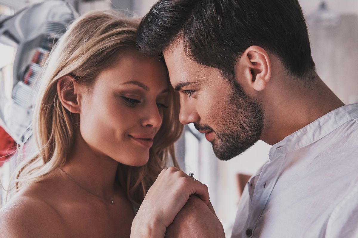 Couple holding hands standing close