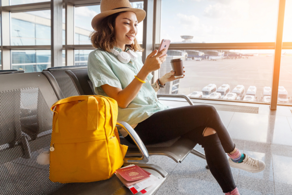 Young woman at the airport waiting to board.