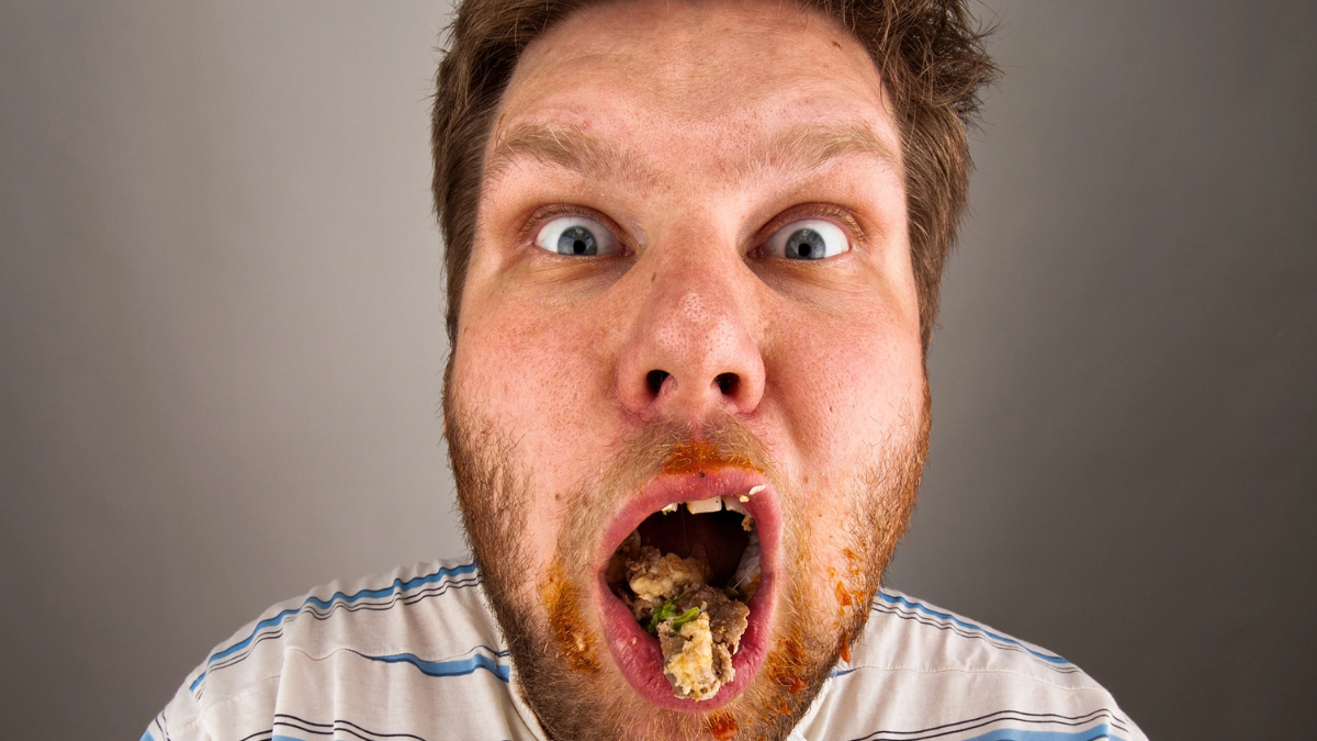 man eating hamburger