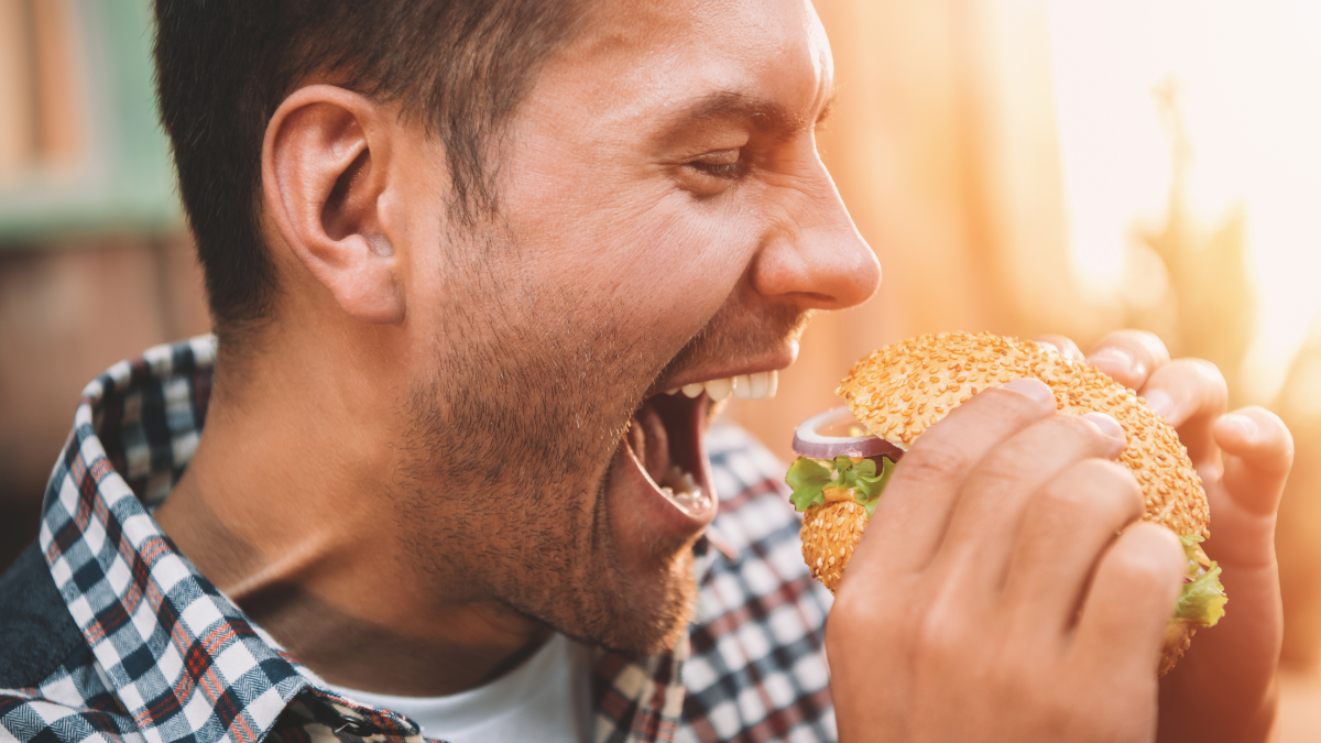 man eating hamburger