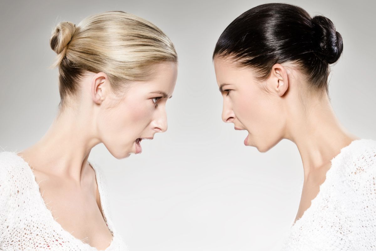 two women face to face looking angry