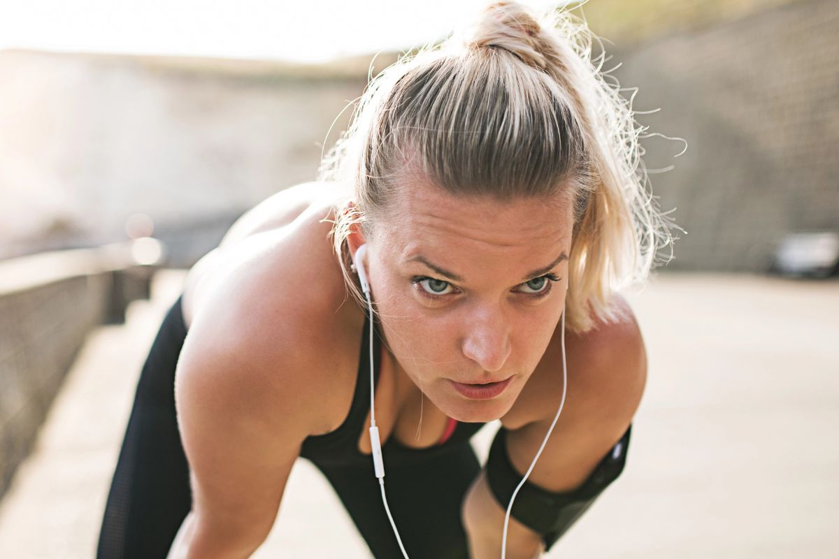 woman bent down to catch her breath before running again