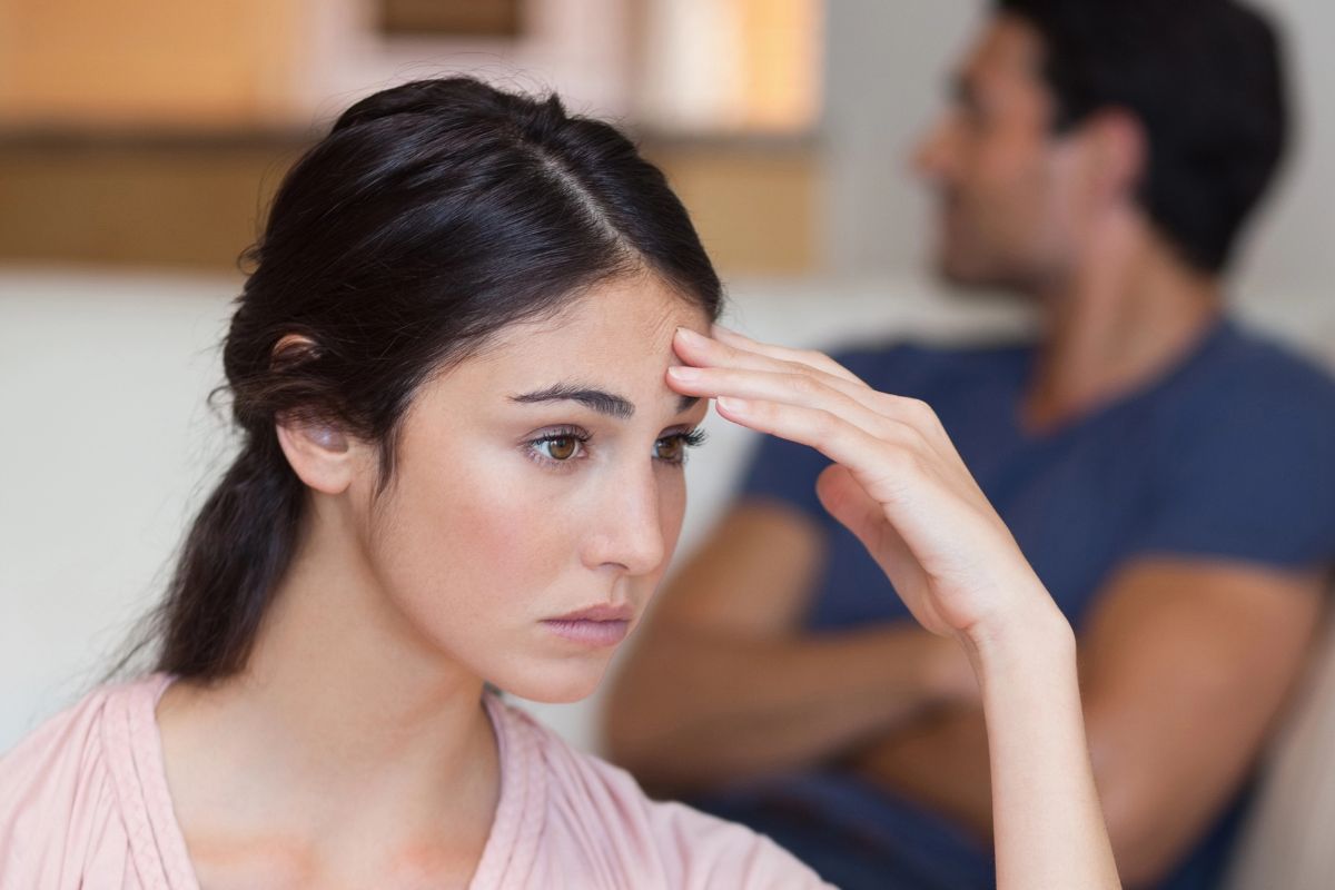 woman holding her head upset