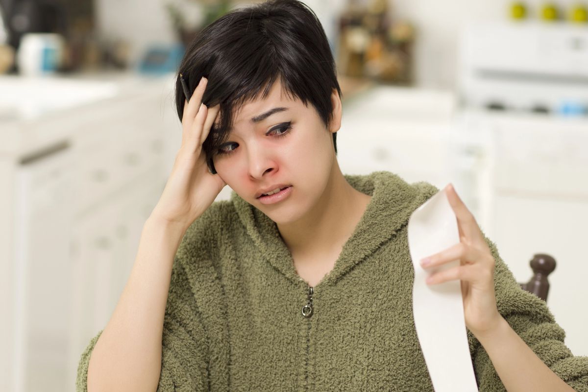 woman looking at a bill worries.