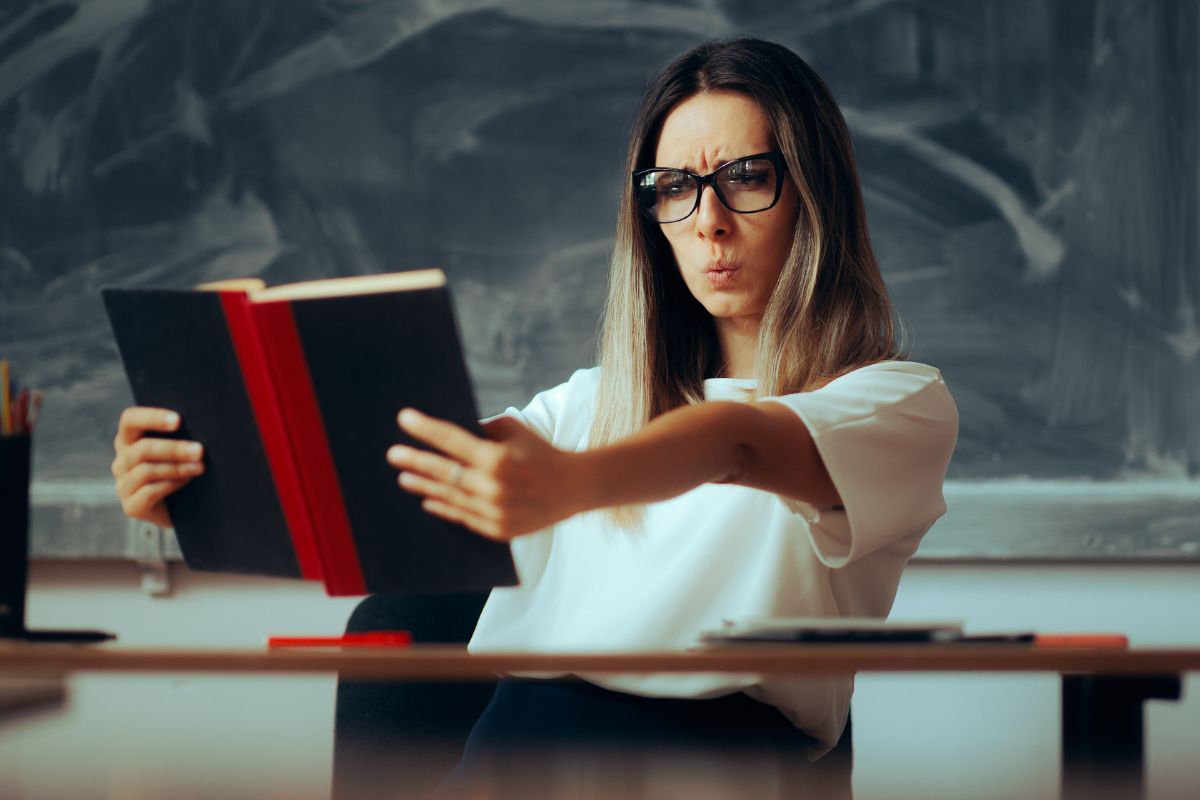 _woman looking at a book in question.