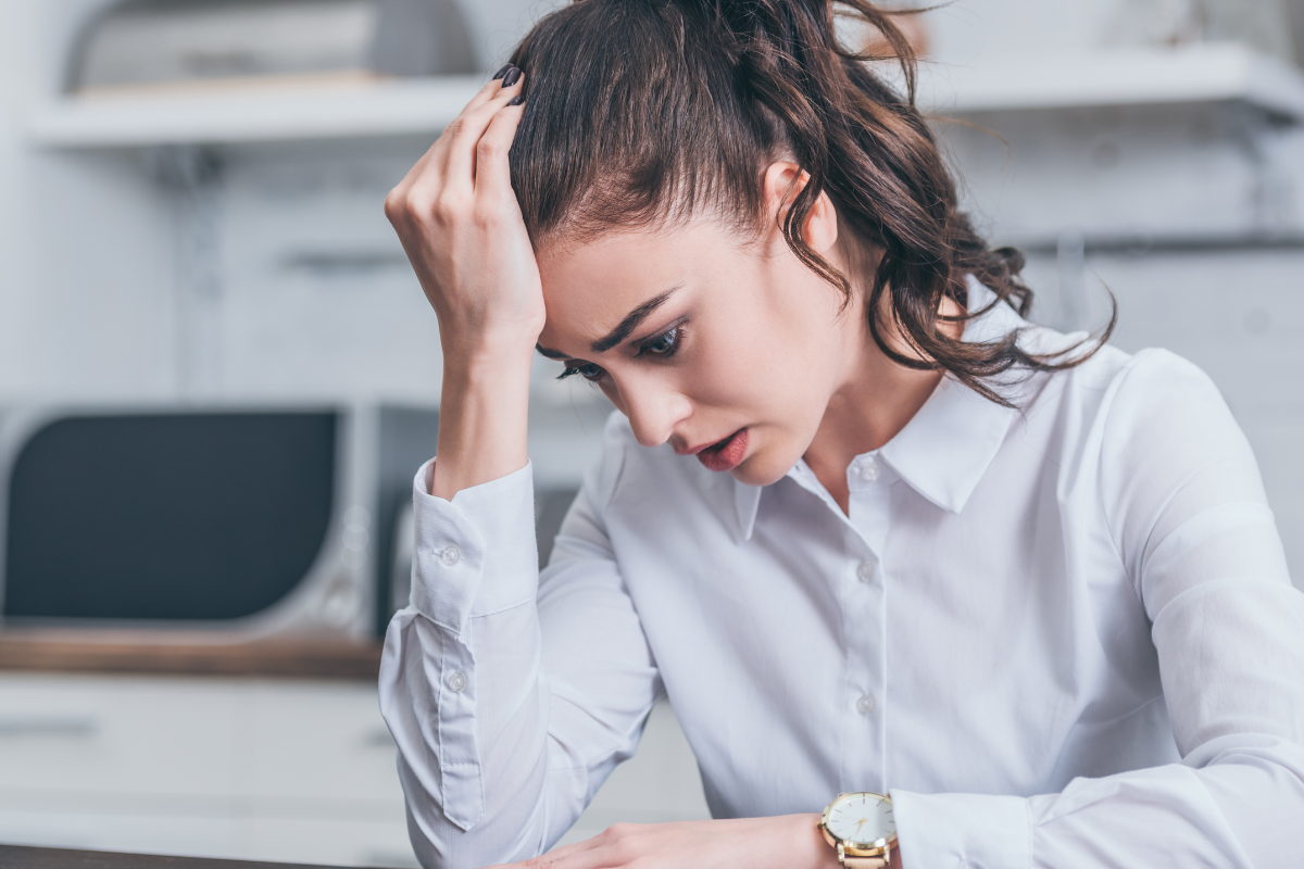woman looking stressed at work.