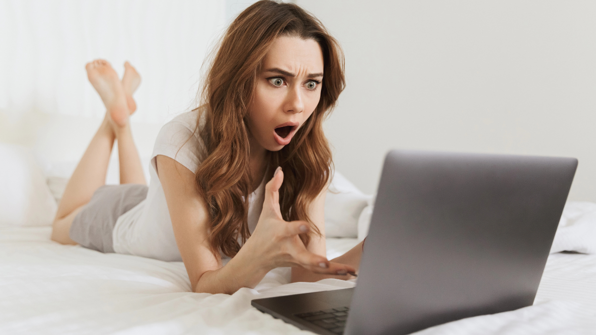 woman on computer on bed