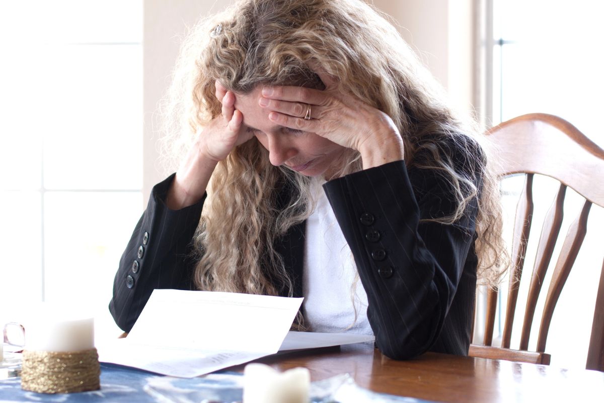 Woman looking stressed out over bills