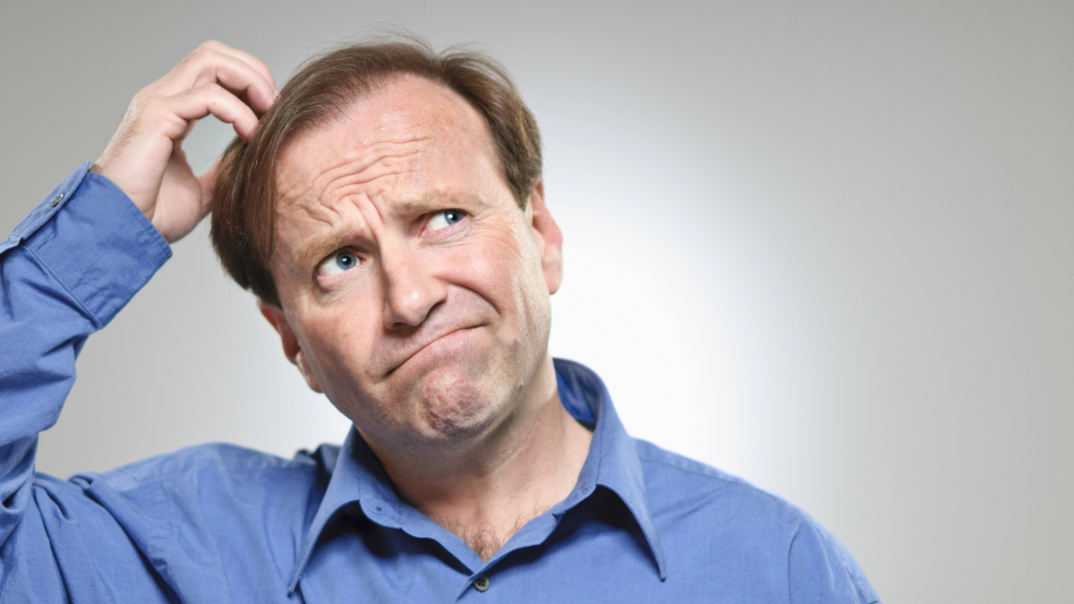 man scratching head