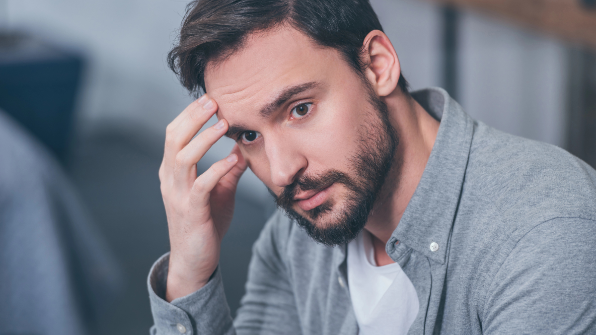 man touching face