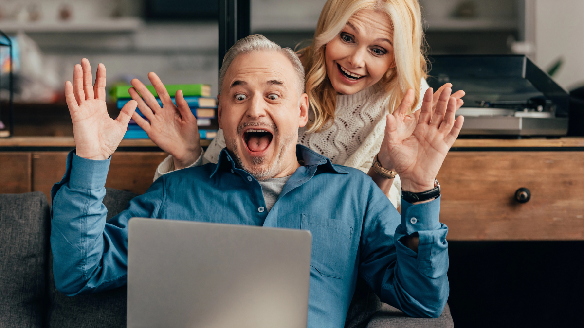 older couple excited on computer