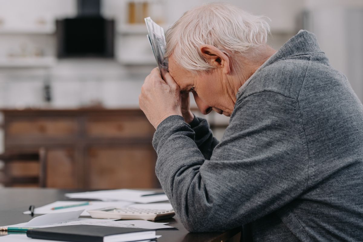 retired man looking upset over his bills