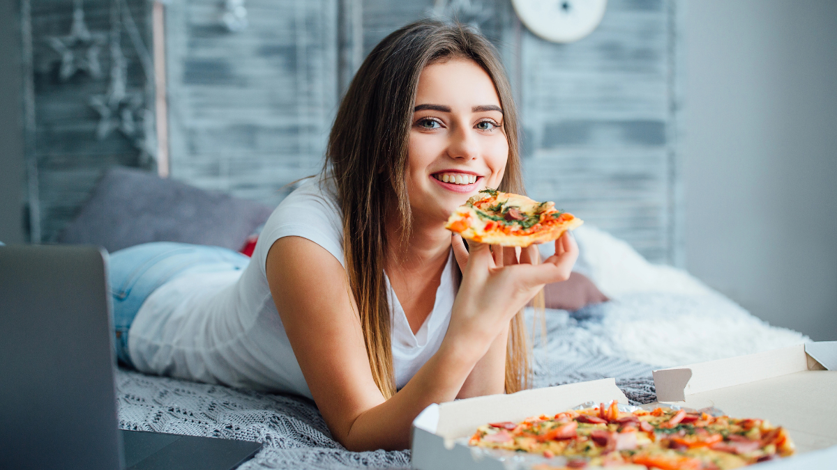 woman eating pizza