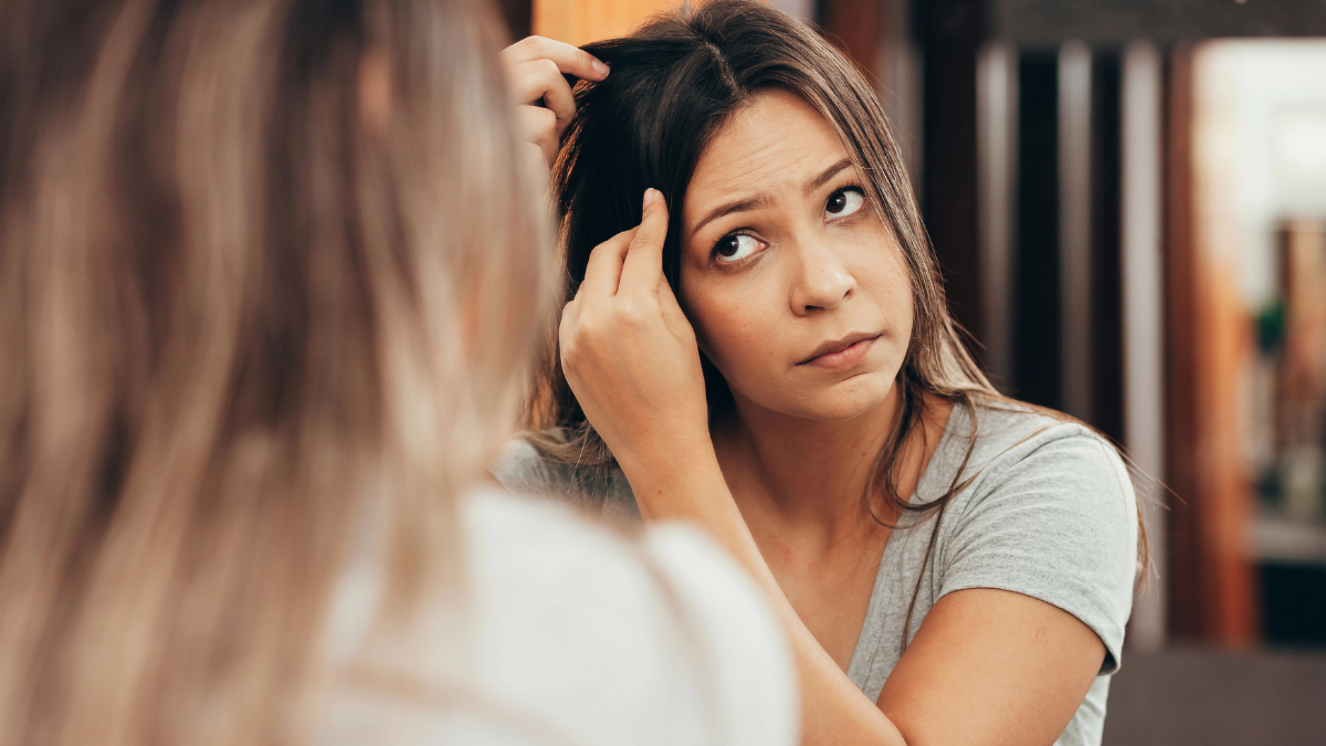 woman looking in mirror