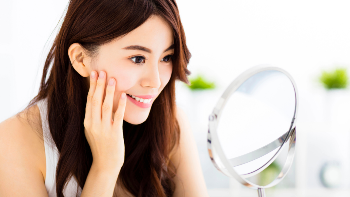 woman looking in mirror
