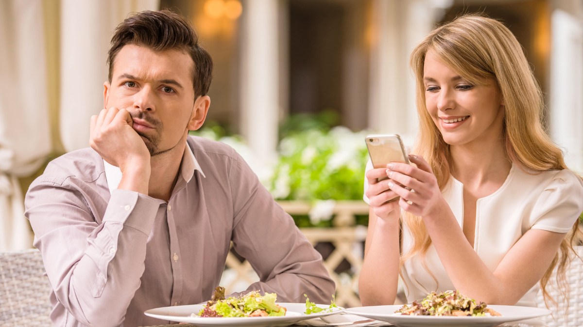 woman on phone and man annoyed