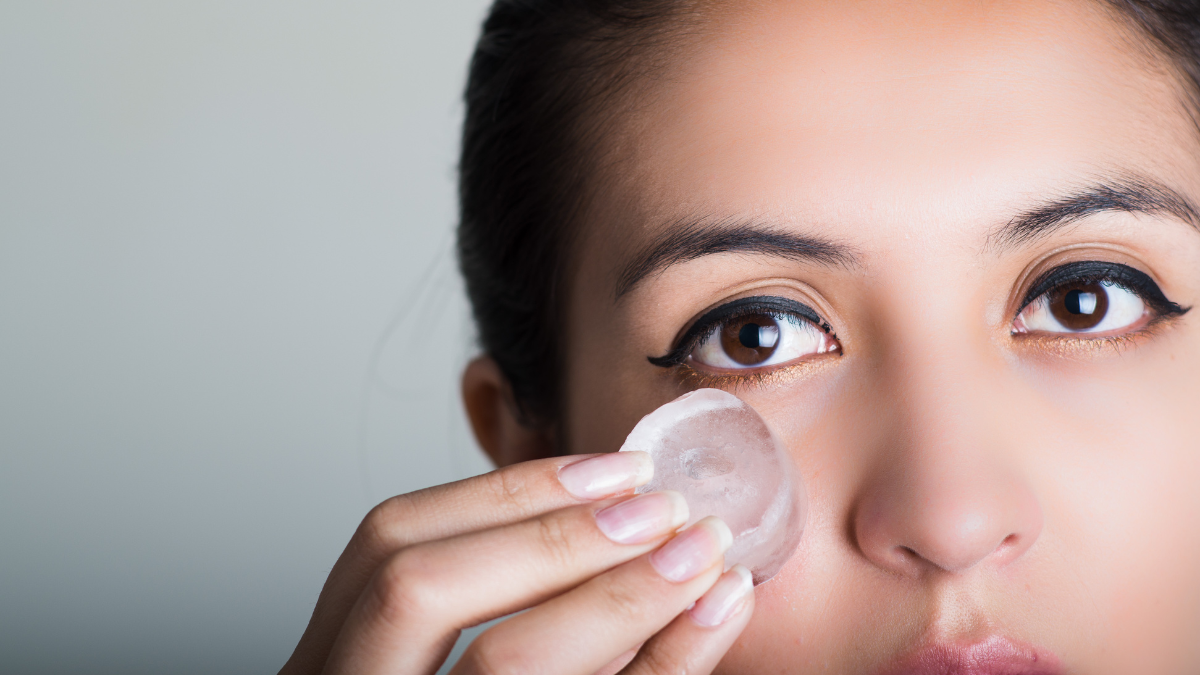 woman putting ice on face