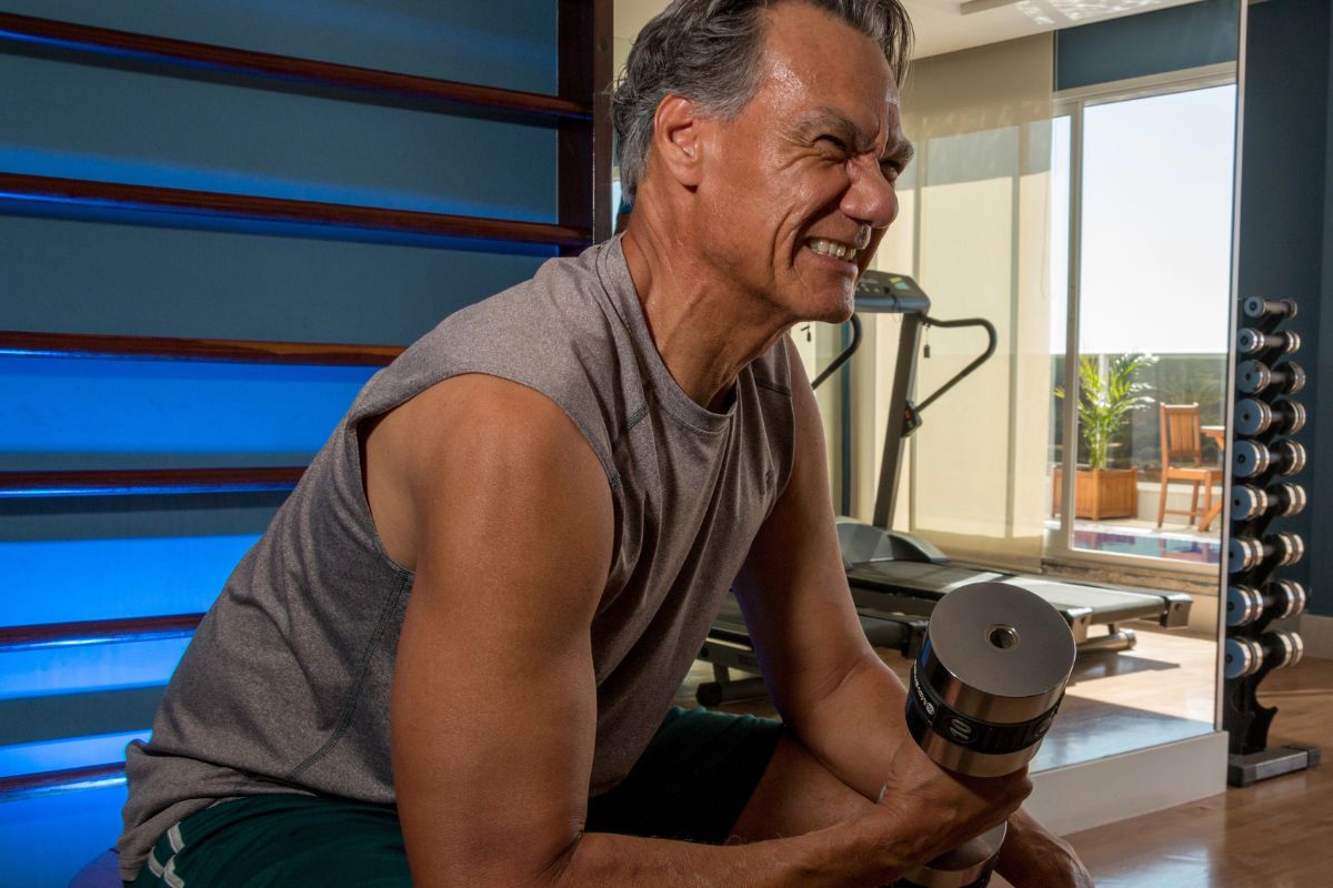 Older man lifting weights at the gym
