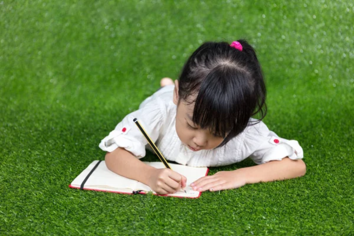 Child Outside Writing