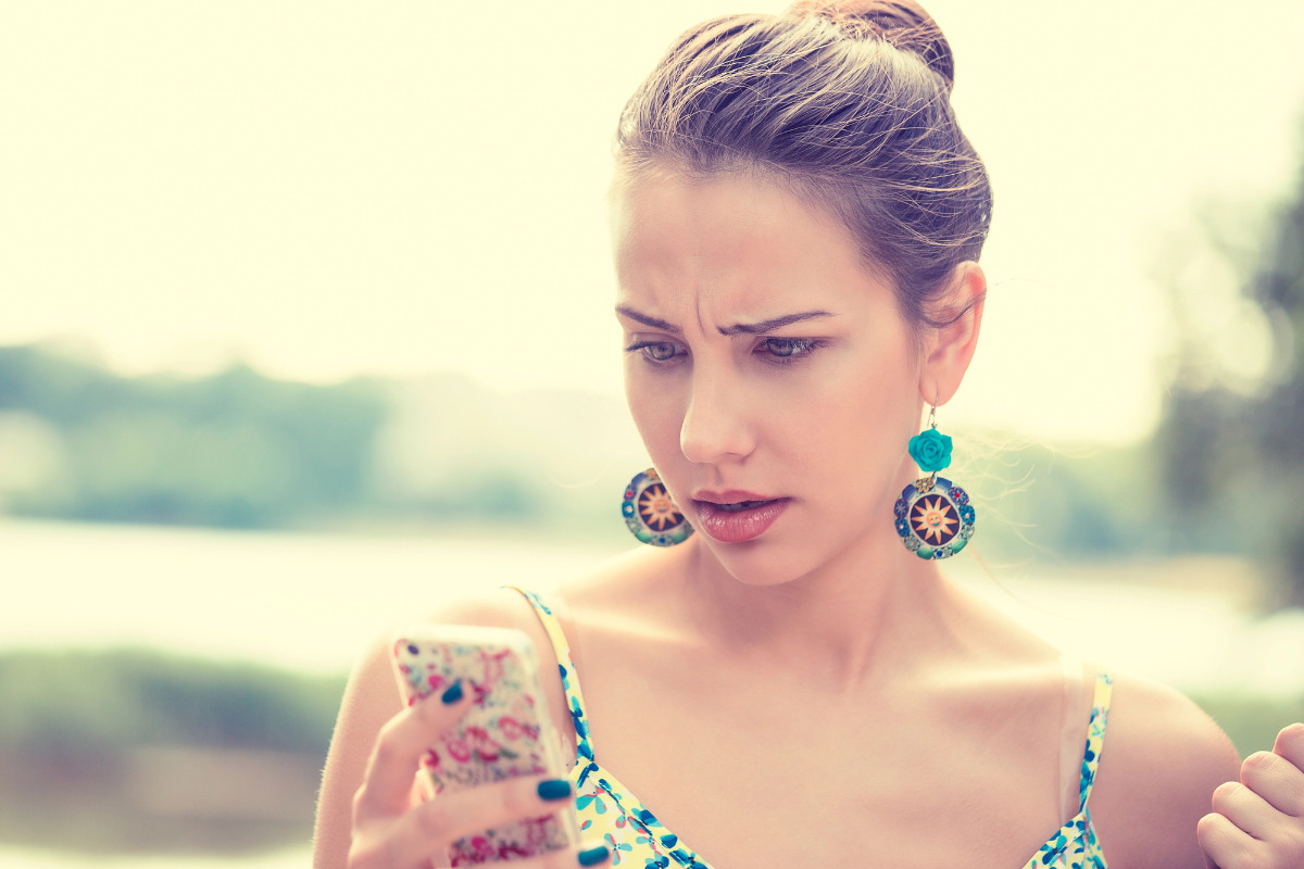 Confused Woman Looking At Phone