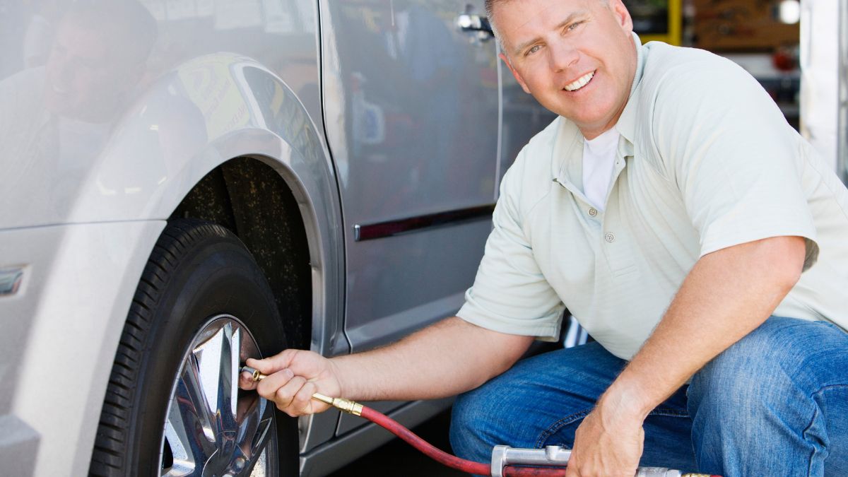 Mechanic putting air in tire