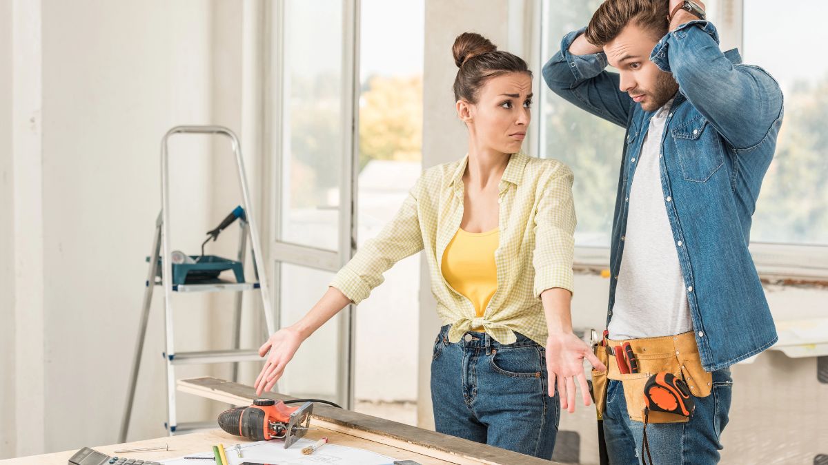 couple with tools looking confused