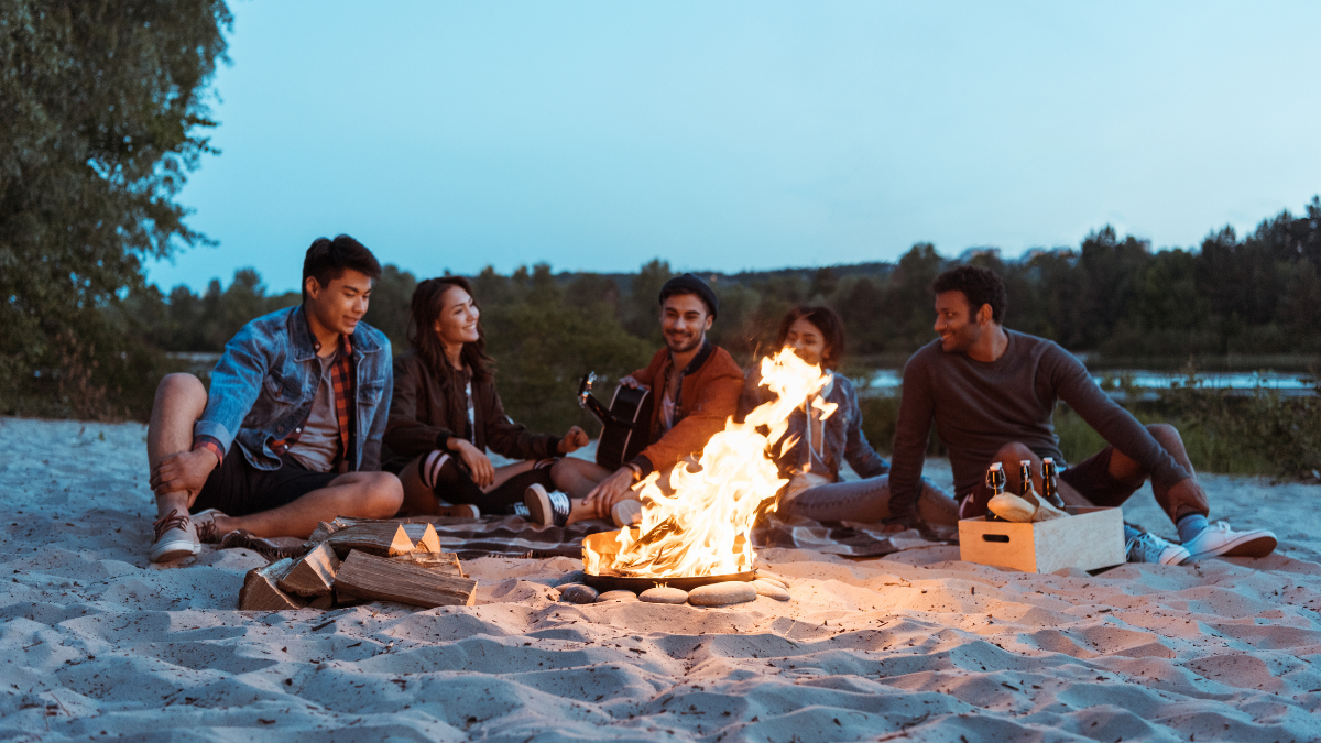friends on beach with fire