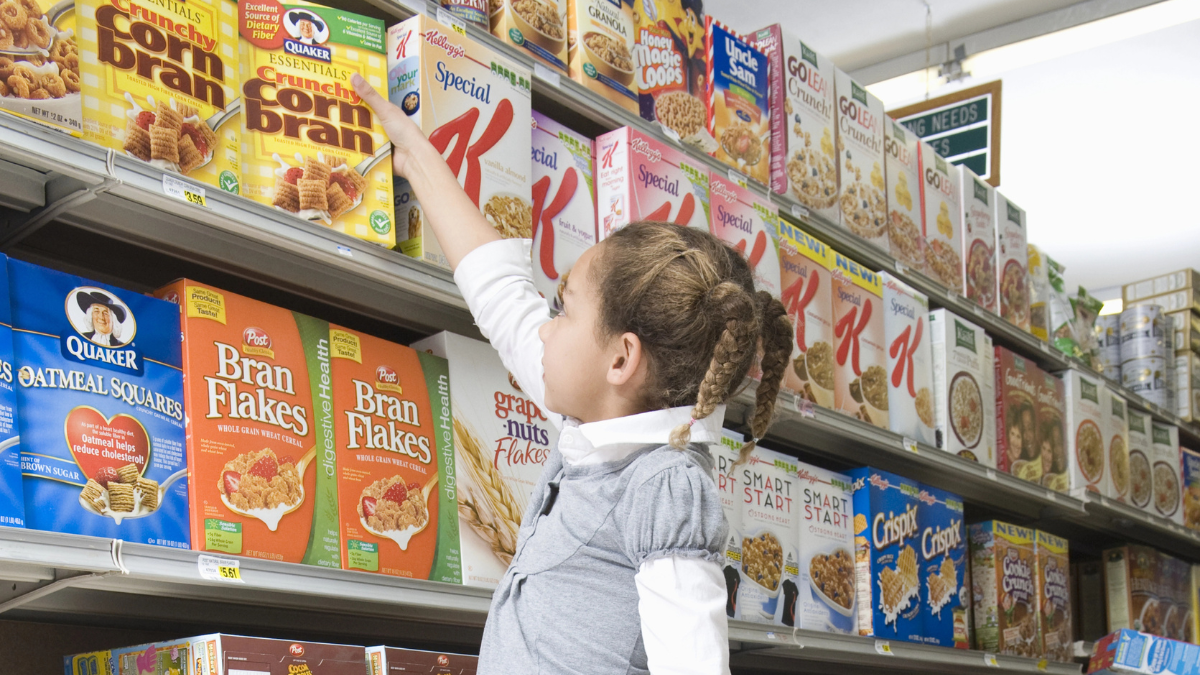 girl reaching for cereal