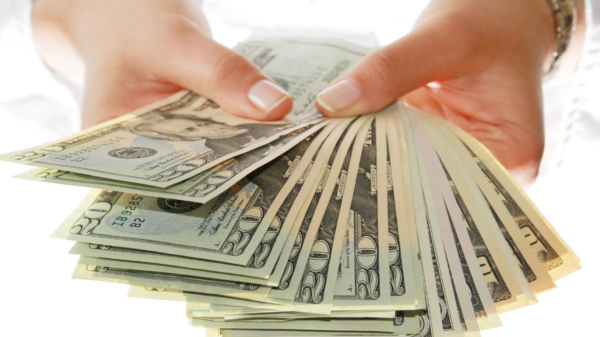 hands holding cash
