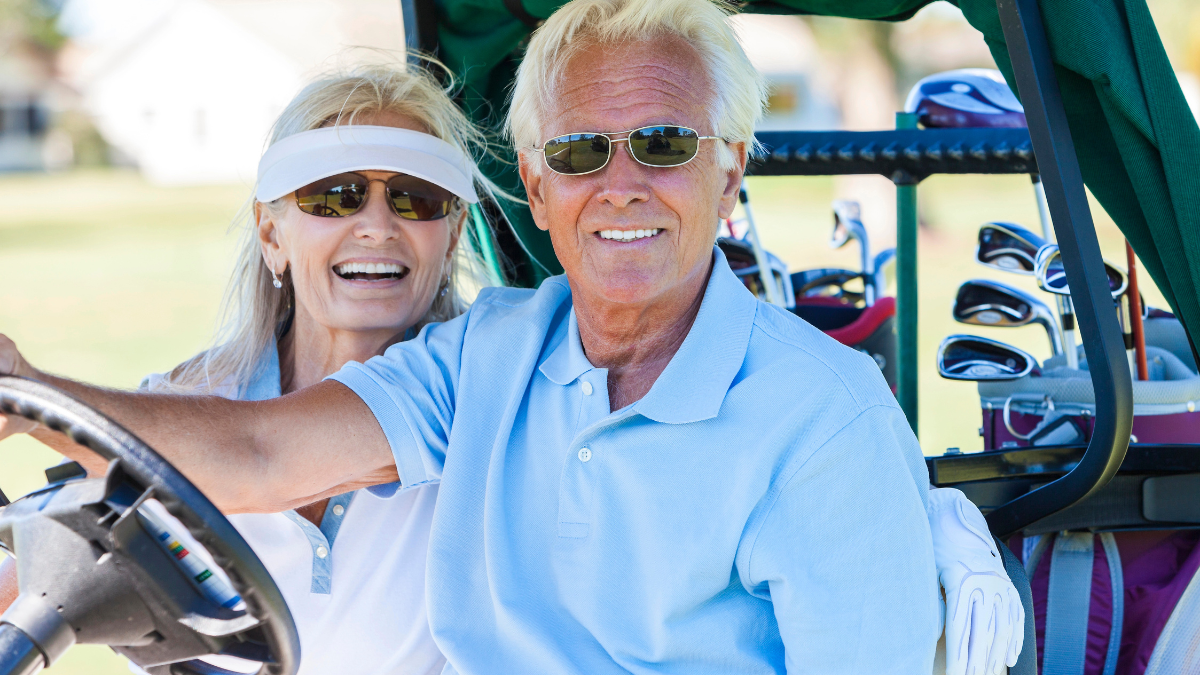 man and woman on golf cart