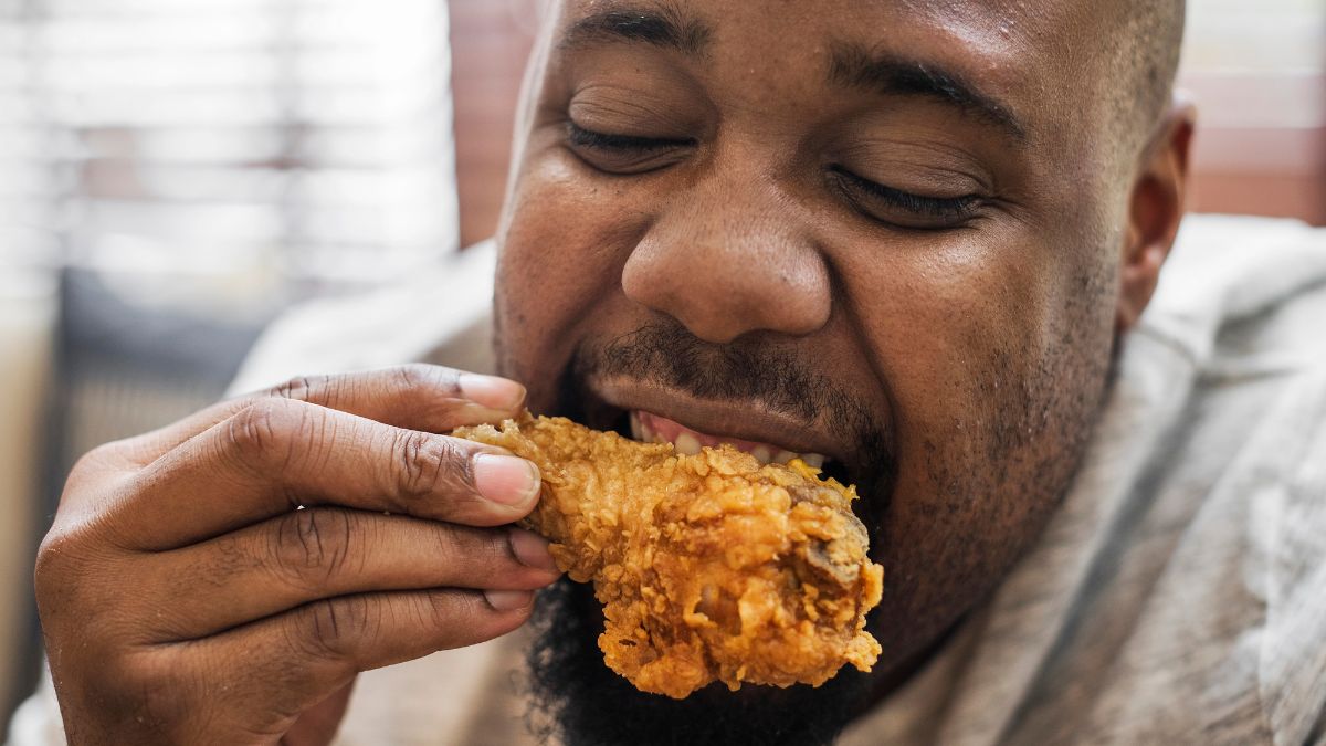 man eating fried chicken