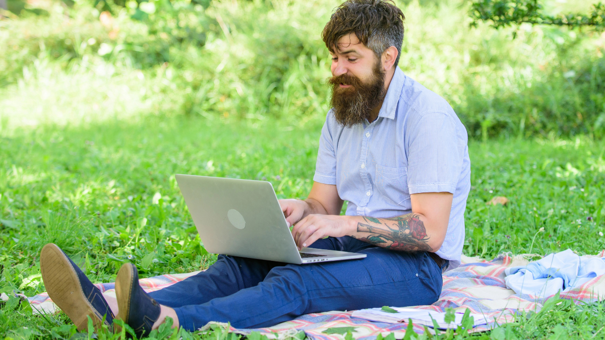 man writing on computer
