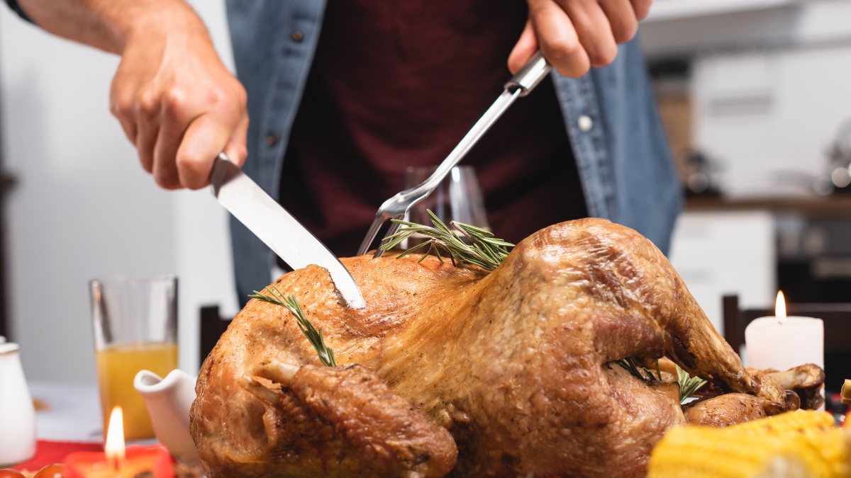 person cutting turkey