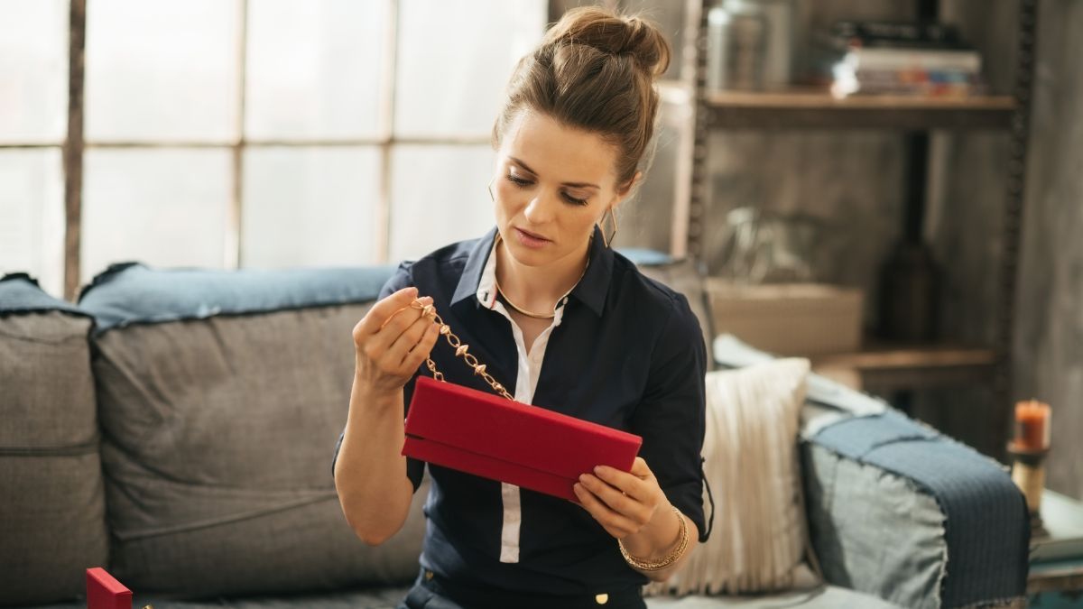woman looking at necklace