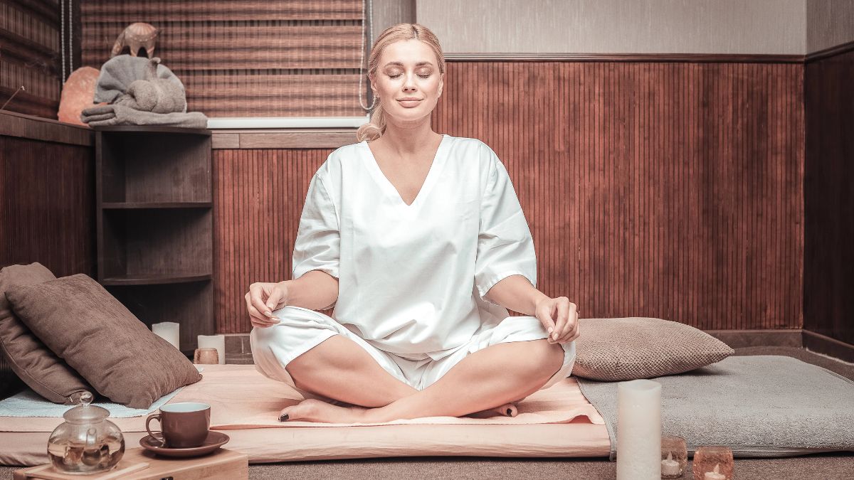 woman meditating in room