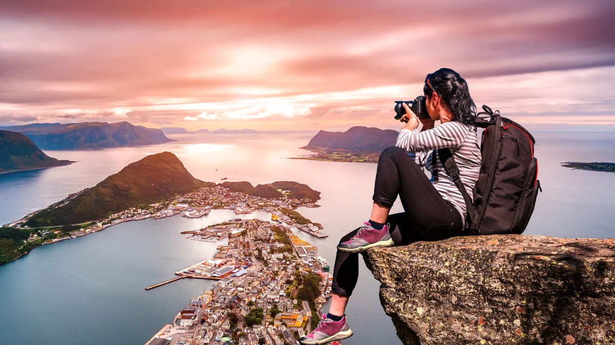 woman taking pictures on mountain