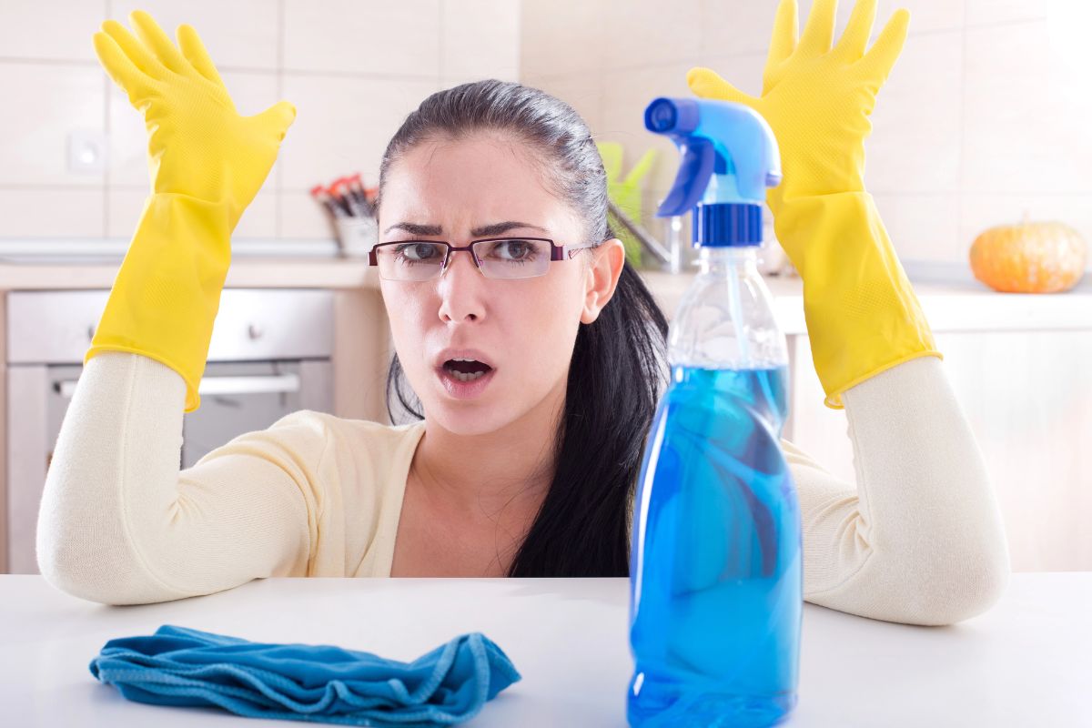 woman with cleaning gloves on unhappy