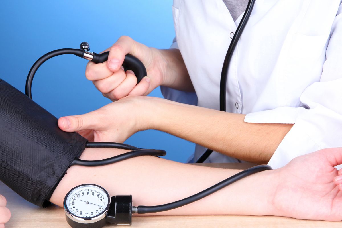 an arm with a blood pressure cuff on