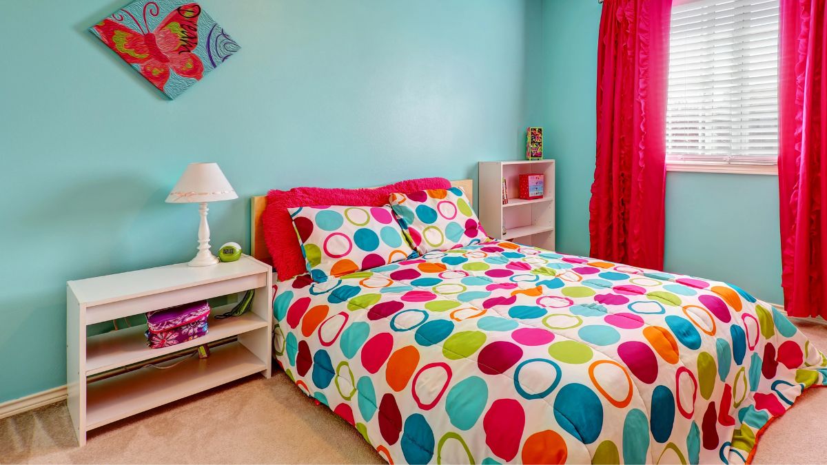 blue bedroom with colorful bed